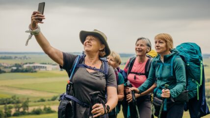 Mature Female Hikers Backpack Hero