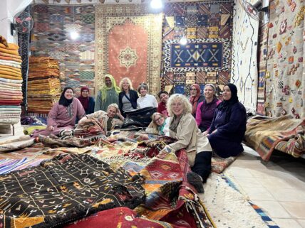 Women with Amazigh rugs in Morocco