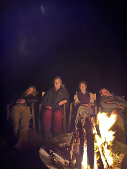 women sitting by the fire