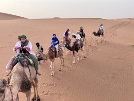 Women enjoying desert ride in Moroccon desert