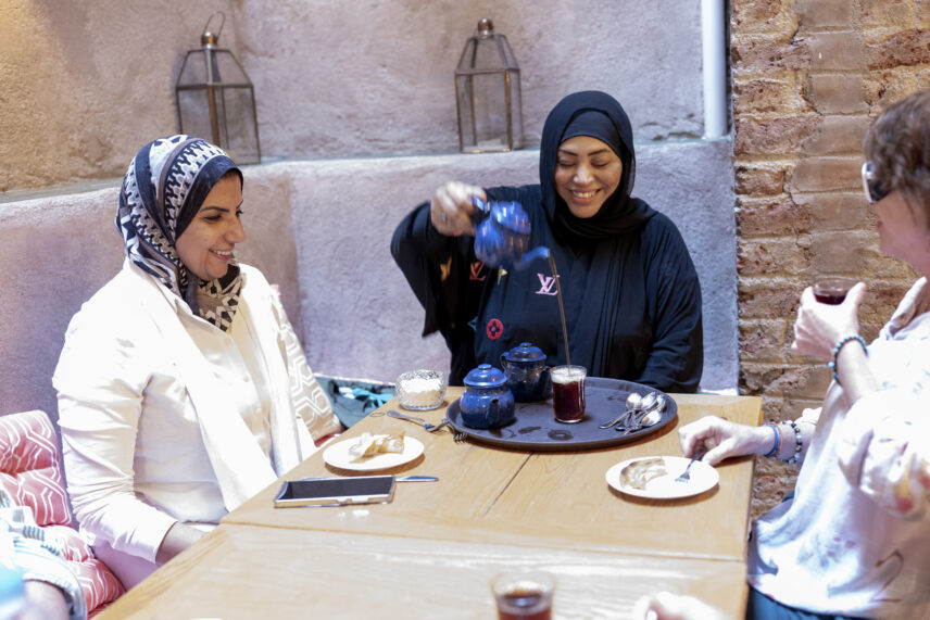 Local Egyptian woman welcoming Wild Women Expeditions travelers into her home