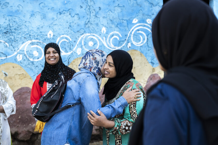Local Egyptian woman welcoming Wild Women Expeditions travelers into her home
