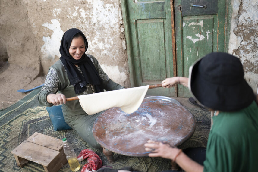 Local Egyptian woman welcoming Wild Women Expeditions travelers into her home