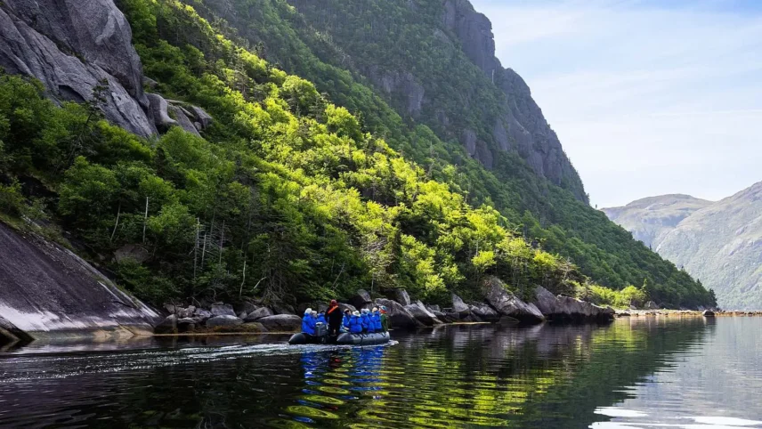Zodiac cruising beneath the mountains of [Gros Morne], Newfoundland